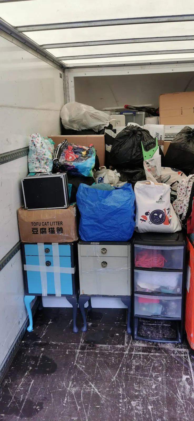Bags, boxes and small drawer units inside a DNE removal van